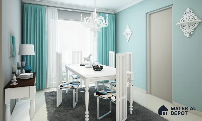 A dining room with a white table and chairs, blue cushions and rug, light blue walls, and a white chandelier, door, and mirror