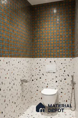 Eclectic bathroom with orange geometric wall tiles and terrazzo wall and floor tiles