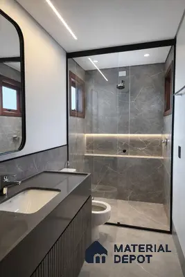 Modern bathroom with grey marble-look wall and floor tiles and matte grey vanity countertop