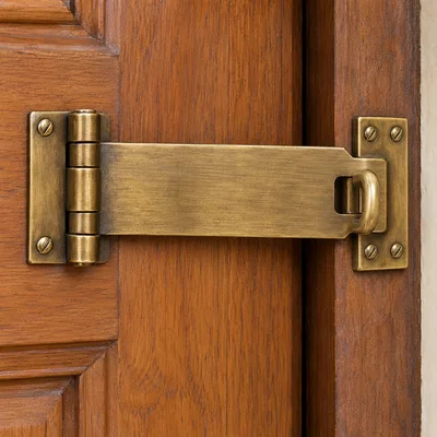 Kadi - antique brass hasp kadi latched across a teak wood door
