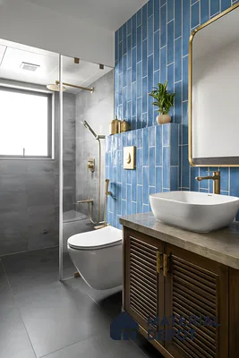 Modern bathroom with blue vertical subway wall tiles, grey stone floor tiles, and wooden vanity of 3 BHK apartment in Kumar Princetown Jalahalli Bengaluru