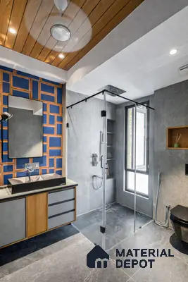 Modern bathroom with grey stone tiles, blue geometric accent wall, and wood ceiling panels in 3 BHK apartment Mahaveer Cedar Chikkasandra Bengaluru