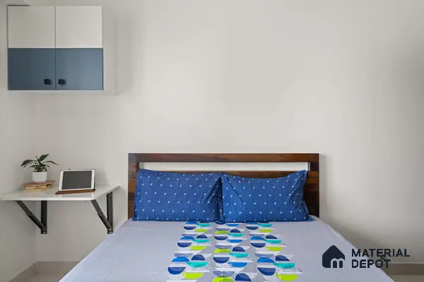 Minimalist bedroom with dual-tone blue and white laminate cabinet and solid wood bed of 2 BHK in Purva Palm Beach Hennur Bengaluru | Material Depot