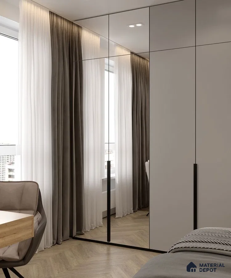 Minimalist bedroom with mirrored wardrobe, taupe laminate, and herringbone wooden flooring | Material Depot