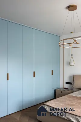 Minimalist bedroom with pastel blue solid color laminate wardrobe and herringbone wooden flooring | Material Depot