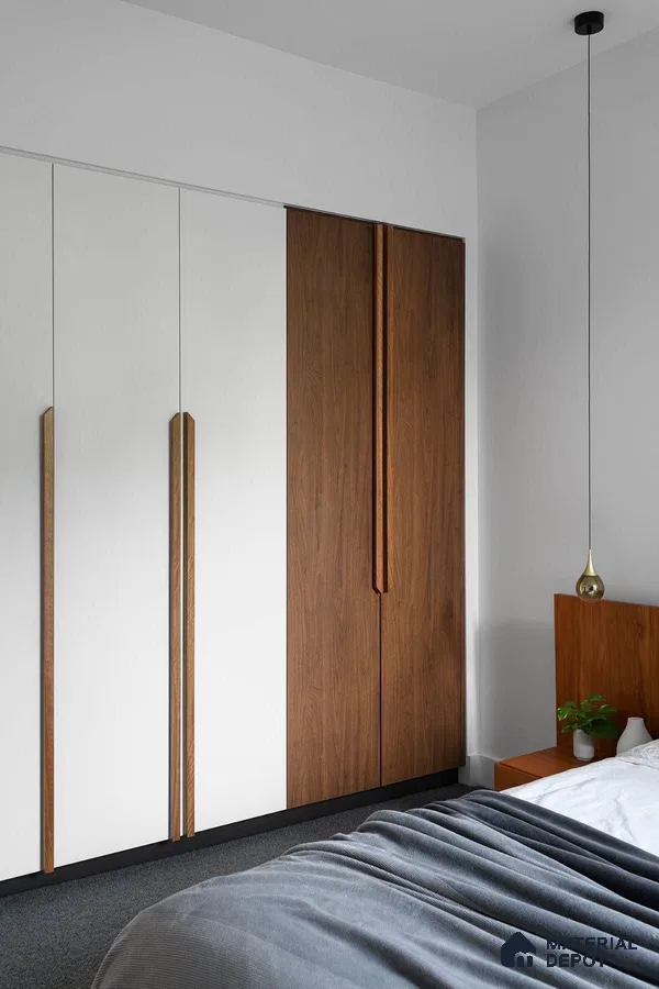 Minimalist bedroom with white and walnut brown laminate wardrobe and grey carpet flooring | Material Depot