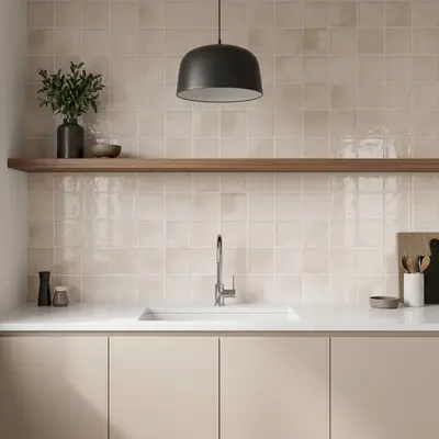 Minimalist kitchen with beige square wall tiles, white quartz countertop, and matte beige laminate cabinets
