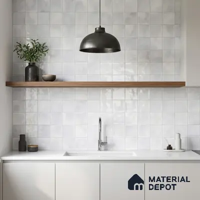 Minimalist kitchen with glossy white square wall tiles, white quartz countertop, and matte white laminate cabinets