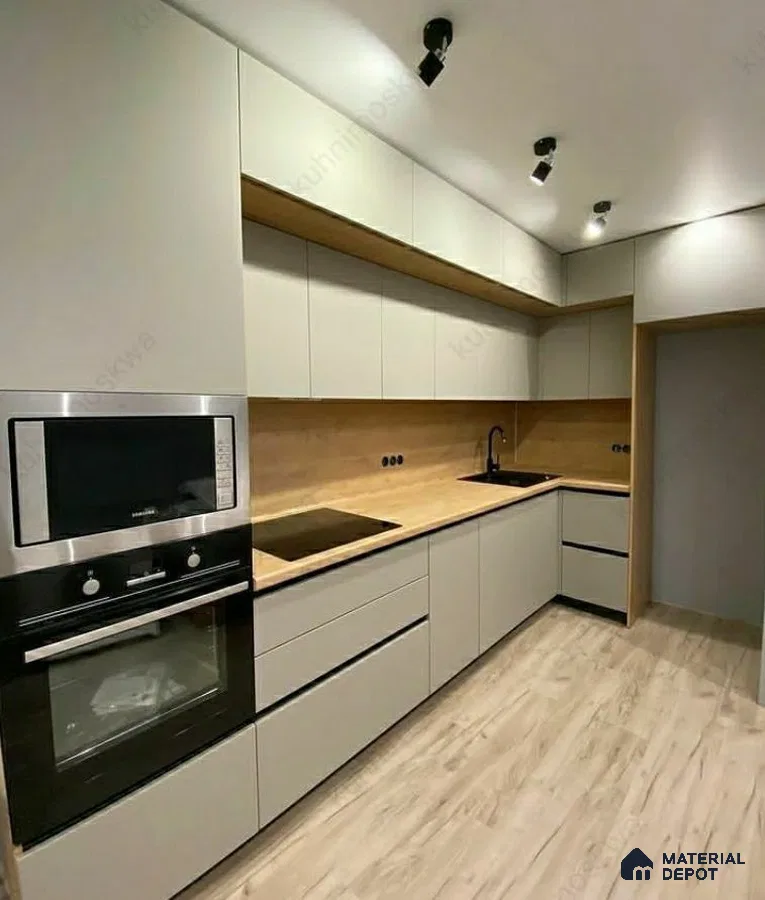 Minimalist kitchen with matte white laminate cabinets, light oak wood backsplash, and wood-look floor tile in Bengaluru | Material Depot