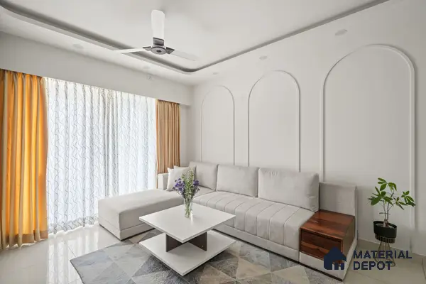 Minimalist living room with white paint, light grey fabric sofa, and geometric patterned rug of 2 BHK in Purva Palm Beach Hennur Bengaluru | Material Depot