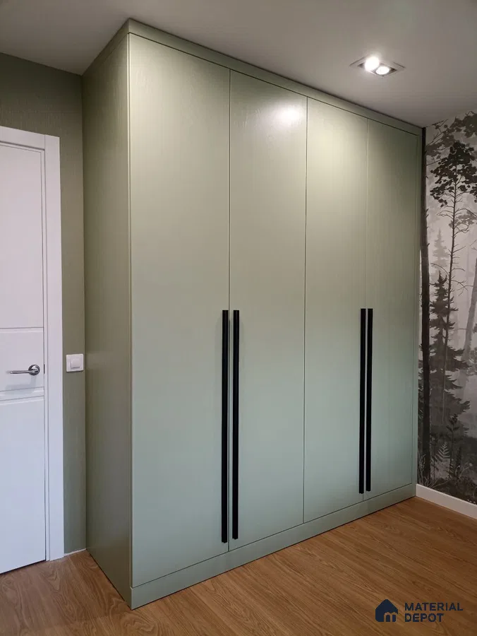Minimalist sage green laminate wardrobe with black handles and wood-look flooring | Material Depot