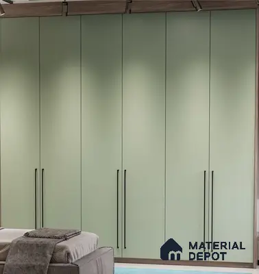 Minimalist sage green solid color laminate wardrobe with black handles in bedroom | Material Depot