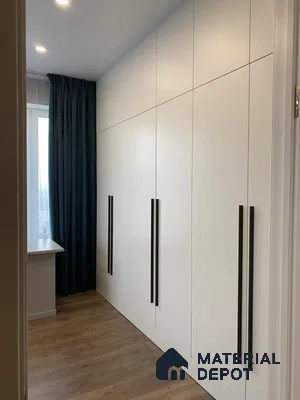 Minimalist wardrobe with frosty white laminate shutters and oak wood flooring | Material Depot