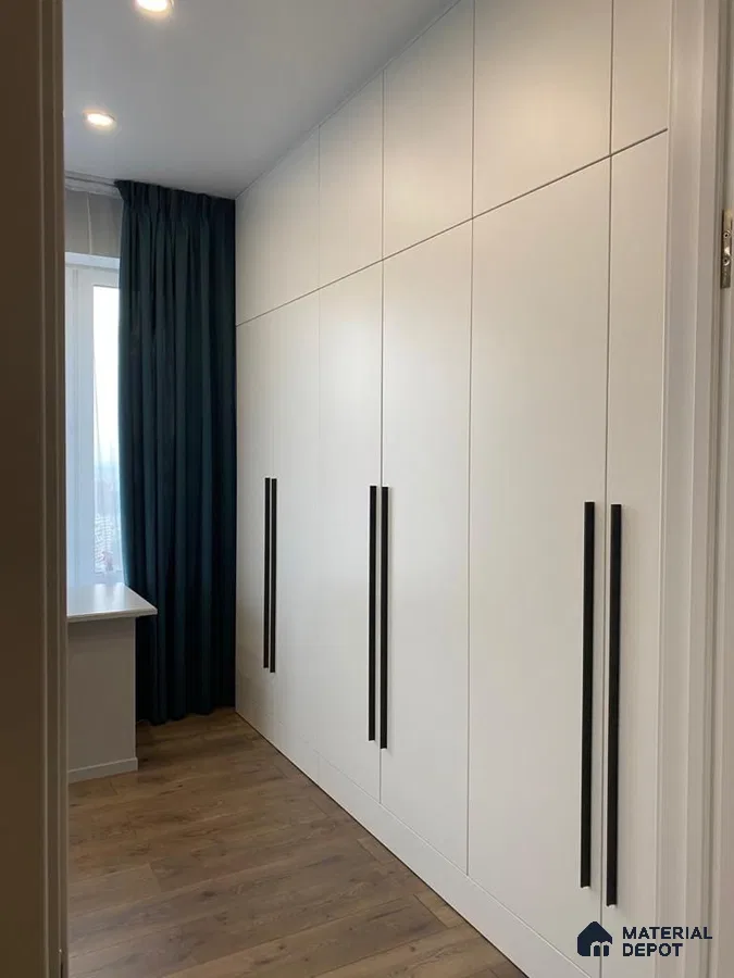 Minimalist wardrobe with frosty white laminate shutters and oak wood flooring | Material Depot