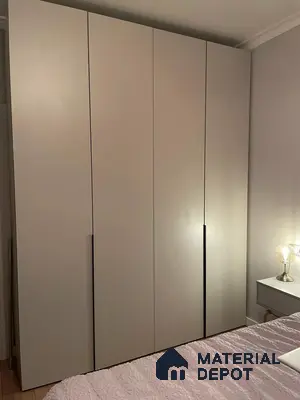 Minimalist wardrobe with matte beige laminate shutters in bedroom | Material Depot