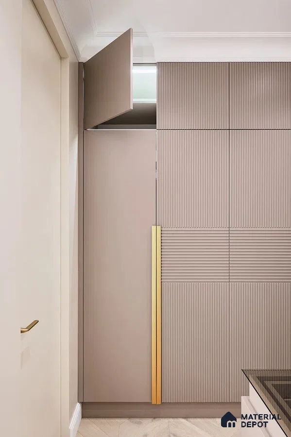 Minimalist wardrobe with taupe fluted laminate and gold accent handle | Material Depot