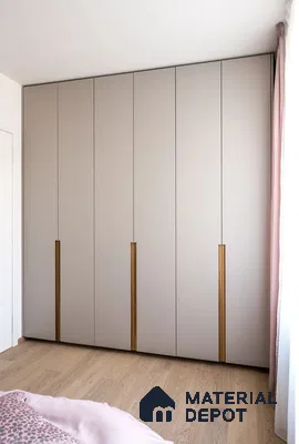 Minimalist wardrobe with taupe matte laminate shutters and oak wood handles in bedroom | Material Depot