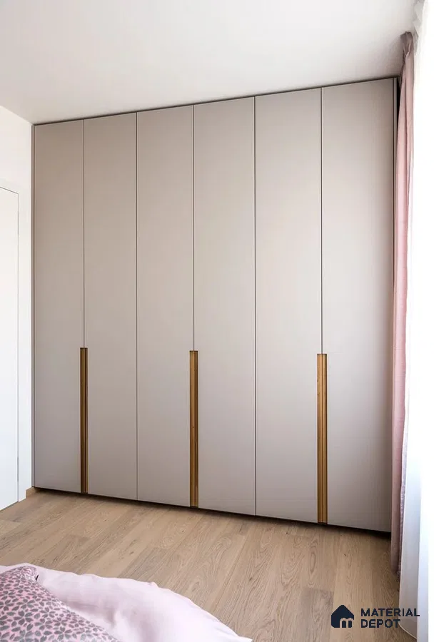 Minimalist wardrobe with taupe matte laminate shutters and oak wood handles in bedroom | Material Depot