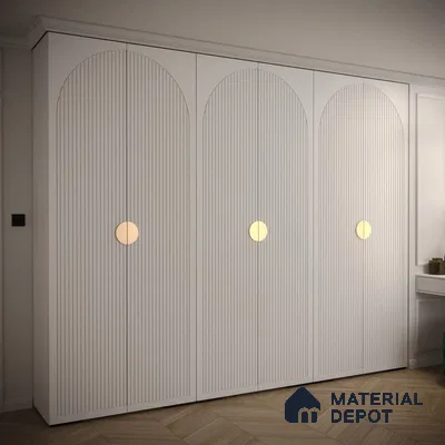 Minimalist white fluted wardrobe with gold circular handles and herringbone wooden flooring | Material Depot