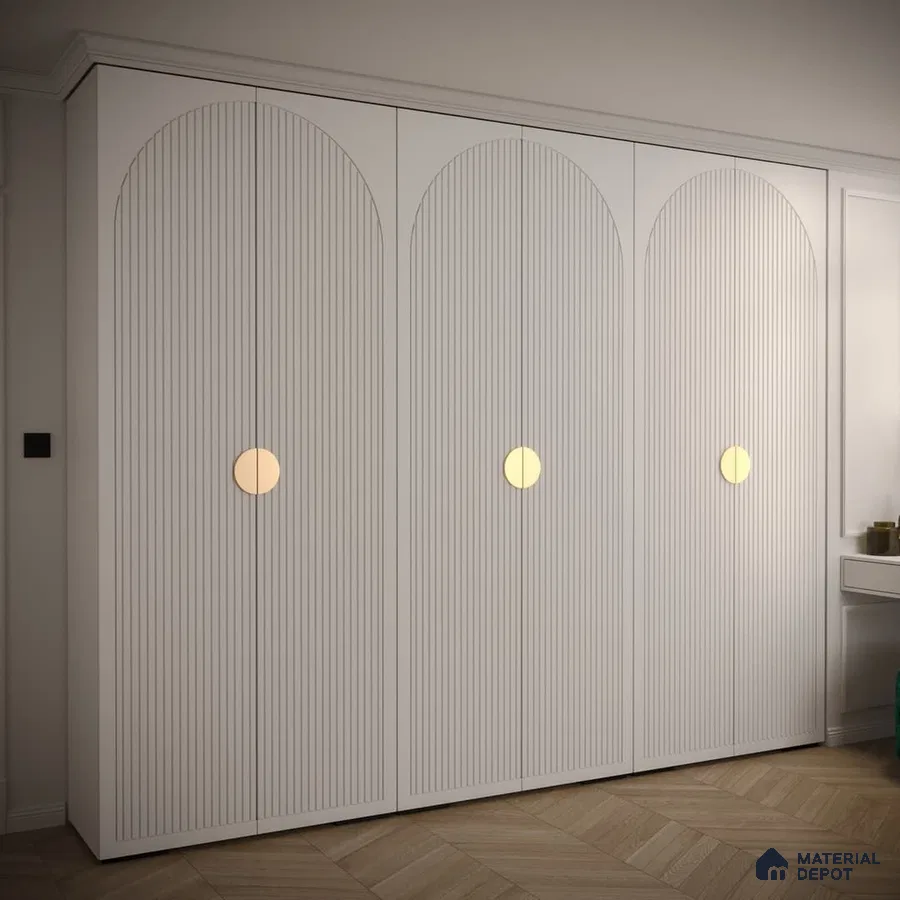 Minimalist white fluted wardrobe with gold circular handles and herringbone wooden flooring | Material Depot