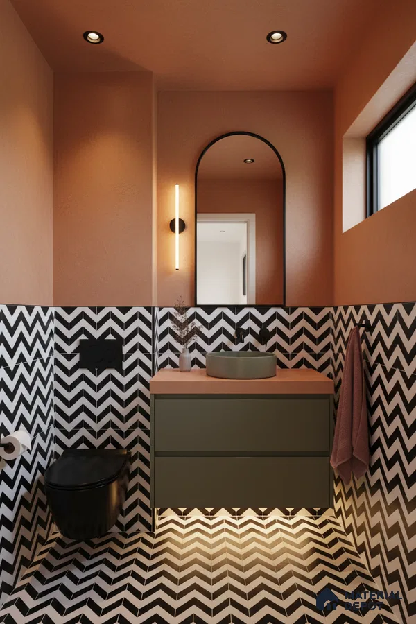 Modern bathroom with black-and-white chevron tiles, olive green vanity, and terracotta countertop in Bengaluru | Material Depot