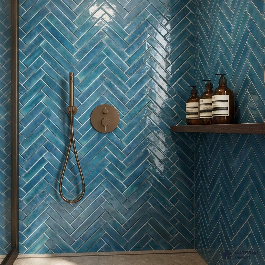 Modern bathroom with blue herringbone subway wall tiles and matte grey floor tile