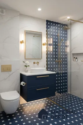 Modern bathroom with blue patterned floor and wall tiles, white marble-look wall tiles, and navy blue vanity in Bengaluru | Material Depot