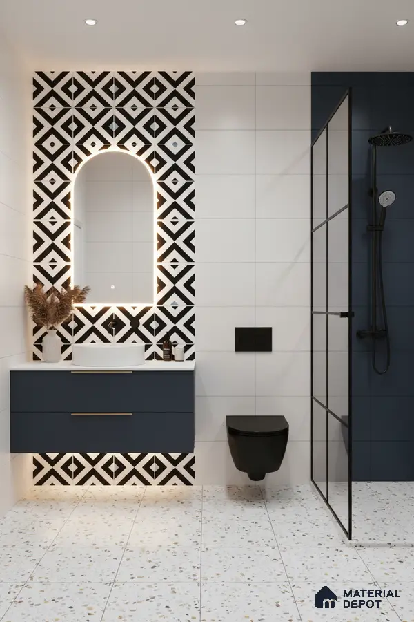 Modern bathroom with geometric black-and-white accent wall tiles, terrazzo floor tiles, and navy blue vanity in Bengaluru | Material Depot