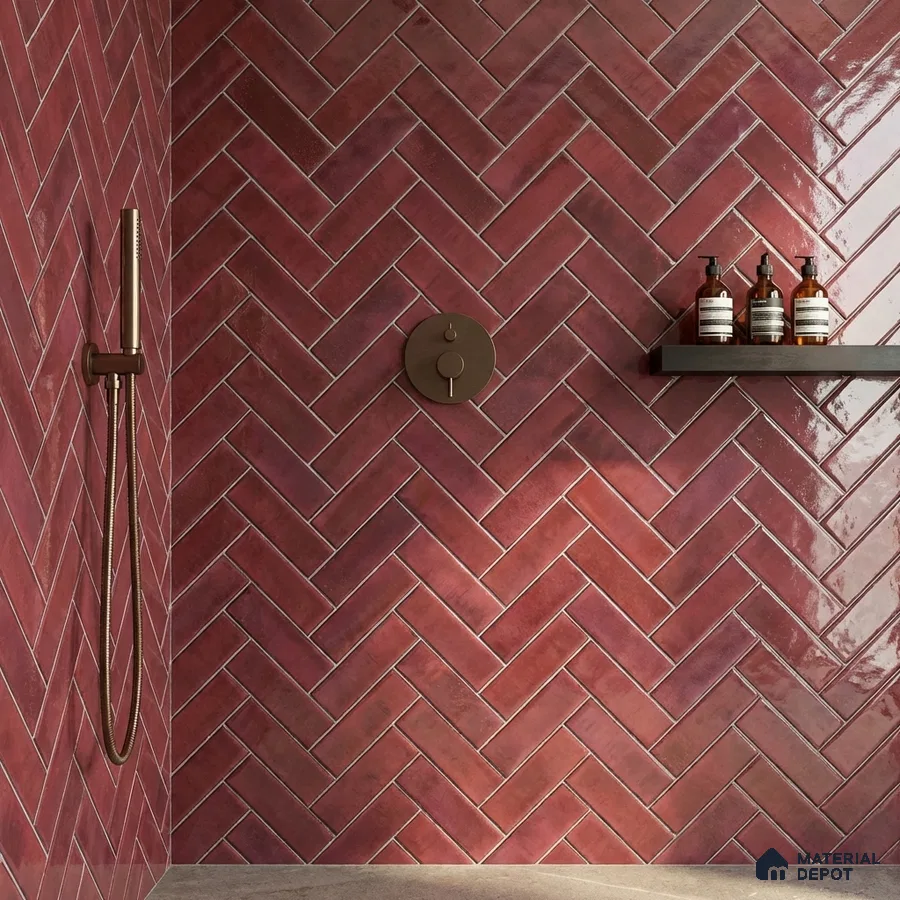 Modern bathroom with glossy maroon herringbone subway wall tiles