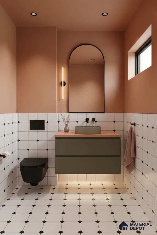 Modern bathroom with olive green vanity, peach wall paint, and white geometric floor and wall tiles in Bengaluru | Material Depot