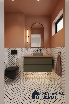 Modern bathroom with olive green vanity, terracotta paint, and chevron patterned white wall and floor tiles in Bengaluru | Material Depot