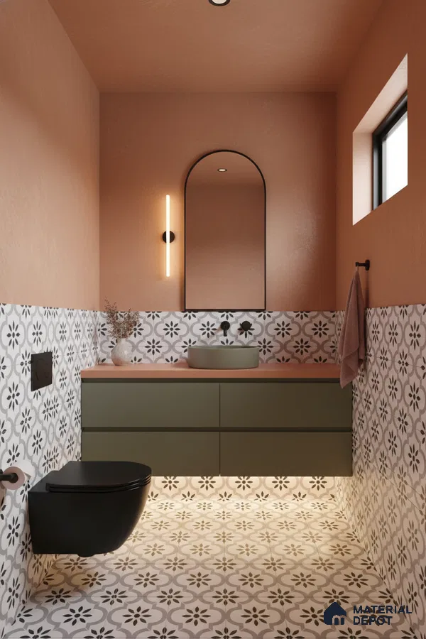 Modern bathroom with olive green vanity, terracotta wall paint, and black-and-white patterned floor and wall tiles in Bengaluru | Material Depot