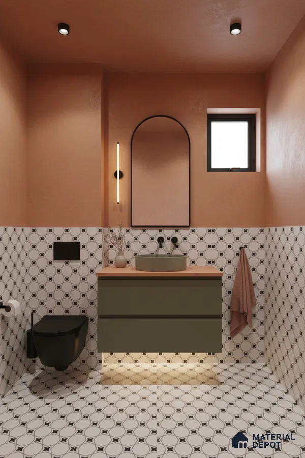 Modern bathroom with olive green vanity, terracotta wall paint, and geometric patterned black-and-white tiles in Bengaluru | Material Depot