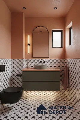 Modern bathroom with peach wall paint, geometric black-and-white patterned tiles, and olive green floating vanity in Bengaluru | Material Depot
