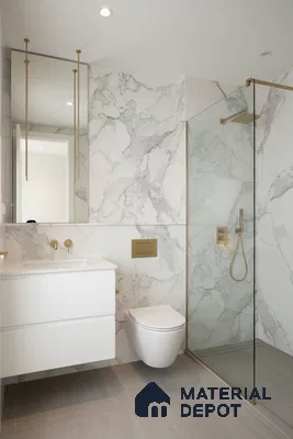 Modern bathroom with white marble-look wall tiles, matte grey floor tiles, and gold accents | Material Depot