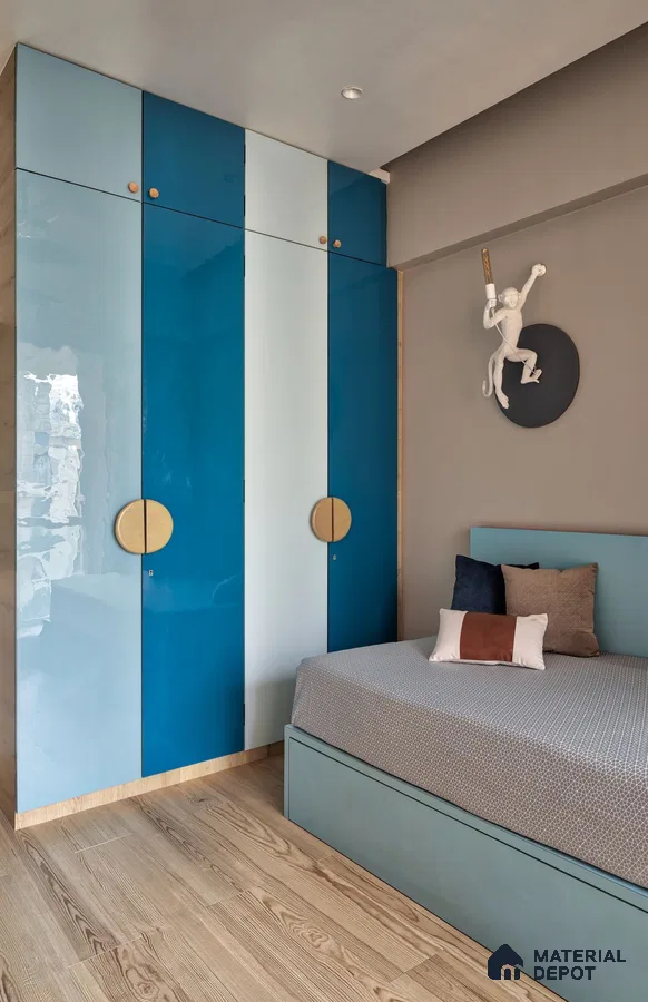 Modern bedroom with blue and white high gloss laminate wardrobe and light wood flooring | Material Depot