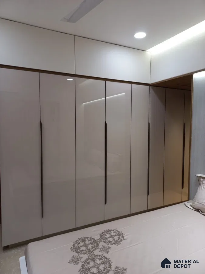 Modern bedroom with high gloss beige laminate wardrobe and white overhead cabinets | Material Depot
