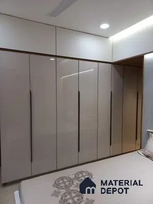 Modern bedroom with high gloss beige laminate wardrobe and white overhead cabinets | Material Depot