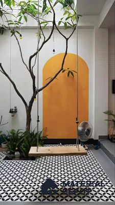 Modern Courtyard with Yellow Accent Wall and Patterned Tiles | Material Depot
