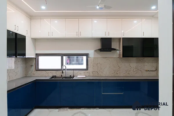 Modern dual tone kitchen with blue and white high gloss laminate, marble-look backsplash, and grey quartz countertop in Bengaluru | Material Depot