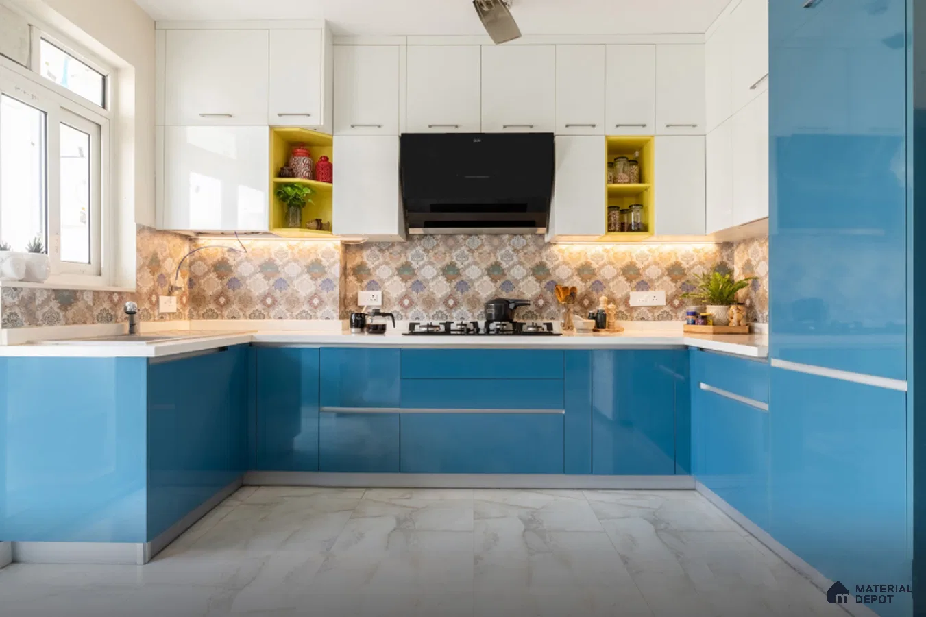 Modern dual tone kitchen with blue high gloss laminate, white laminate, patterned backsplash tile, and white marble floor tile in Bengaluru | Material Depot