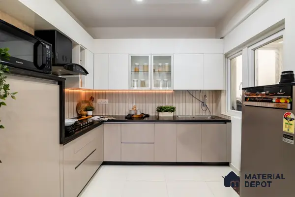 Modern dual tone kitchen with frosty white and beige laminate, black quartz countertop, and vertical beige backsplash tile in Bengaluru | Material Depot