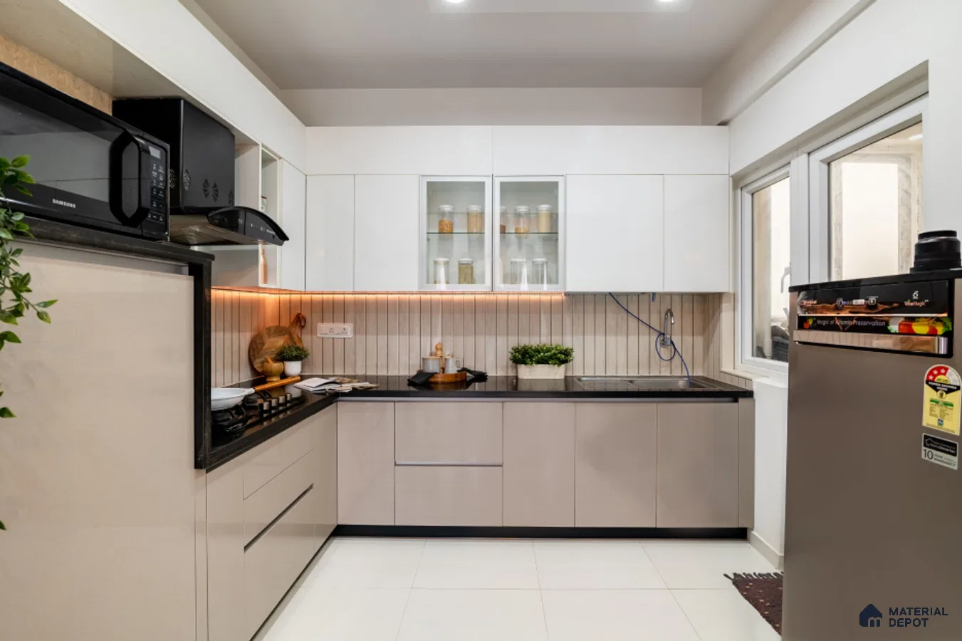 Modern dual tone kitchen with frosty white and beige laminate, black quartz countertop, and vertical beige backsplash tile in Bengaluru | Material Depot
