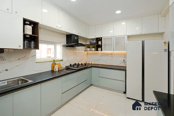 Modern dual tone kitchen with frosty white and pastel green laminate, black quartz countertop, and marble-look backsplash in Bengaluru | Material Depot