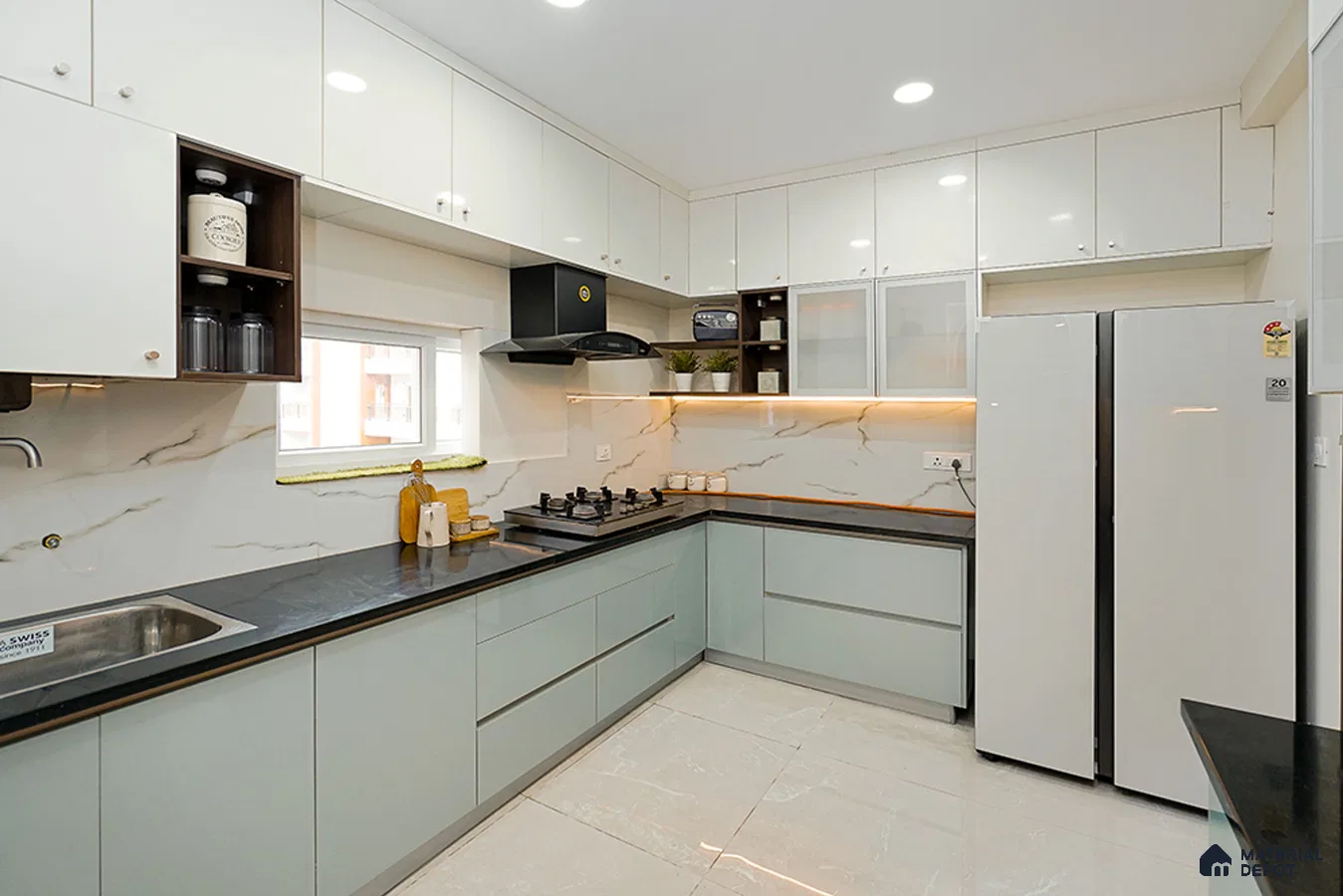 Modern dual tone kitchen with frosty white and pastel green laminate, black quartz countertop, and marble-look backsplash in Bengaluru | Material Depot