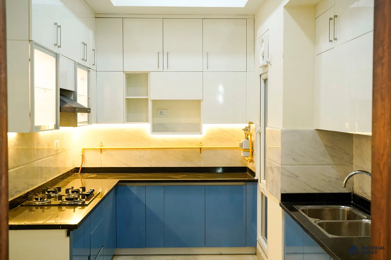 Modern dual tone kitchen with frosty white high gloss laminate, blue matte laminate, and marble look backsplash in Bengaluru | Material Depot