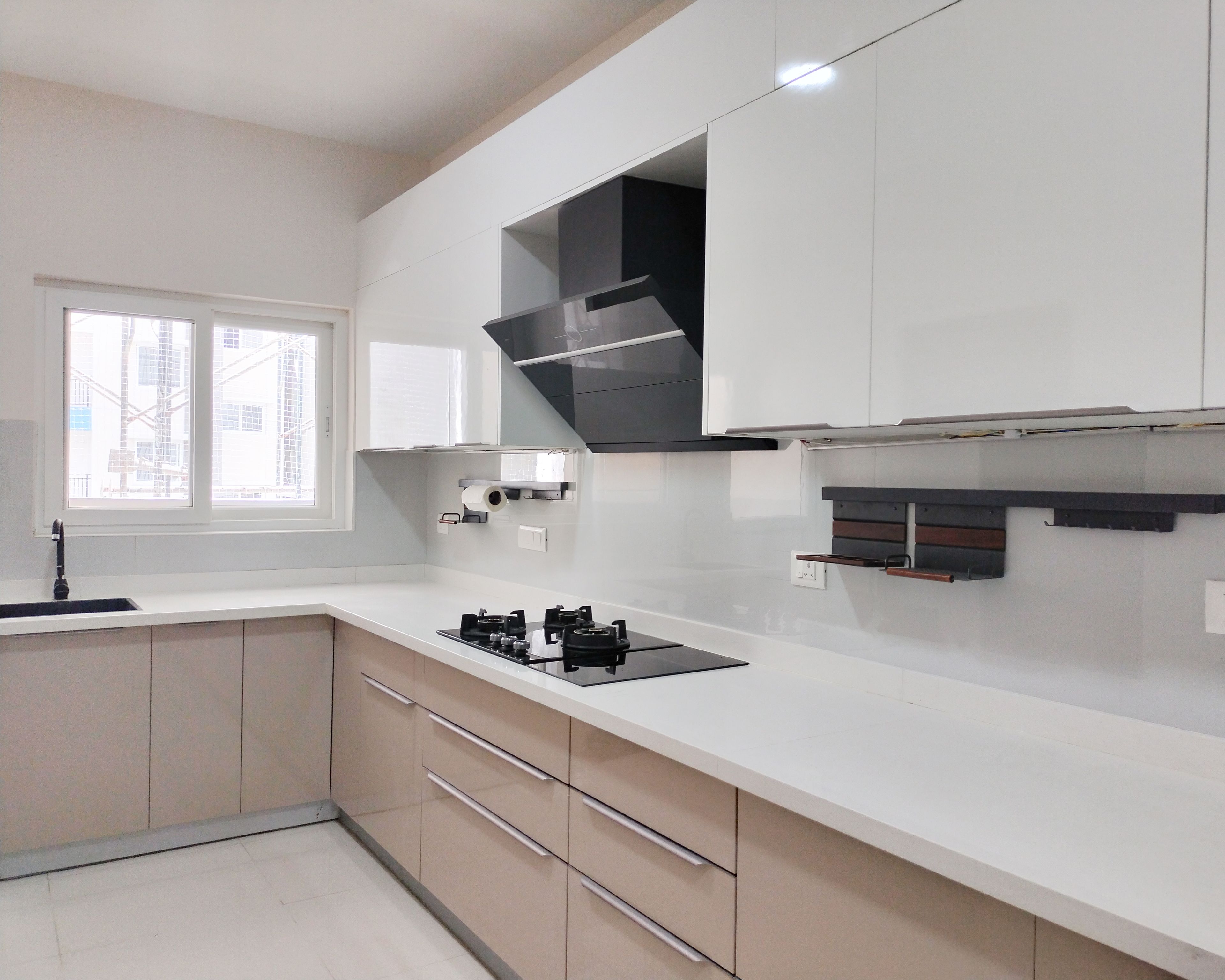 Modern dual tone kitchen with glossy white and beige laminate cabinets and white quartz countertop in Bengaluru | Material Depot