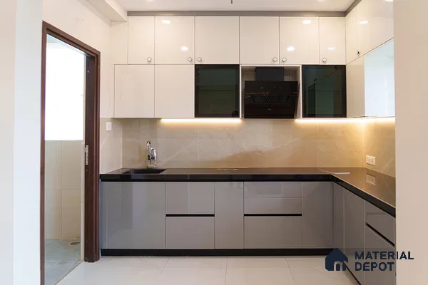 Modern dual tone kitchen with glossy white and grey laminate, black quartz countertop, and beige marble backsplash in Bengaluru | Material Depot