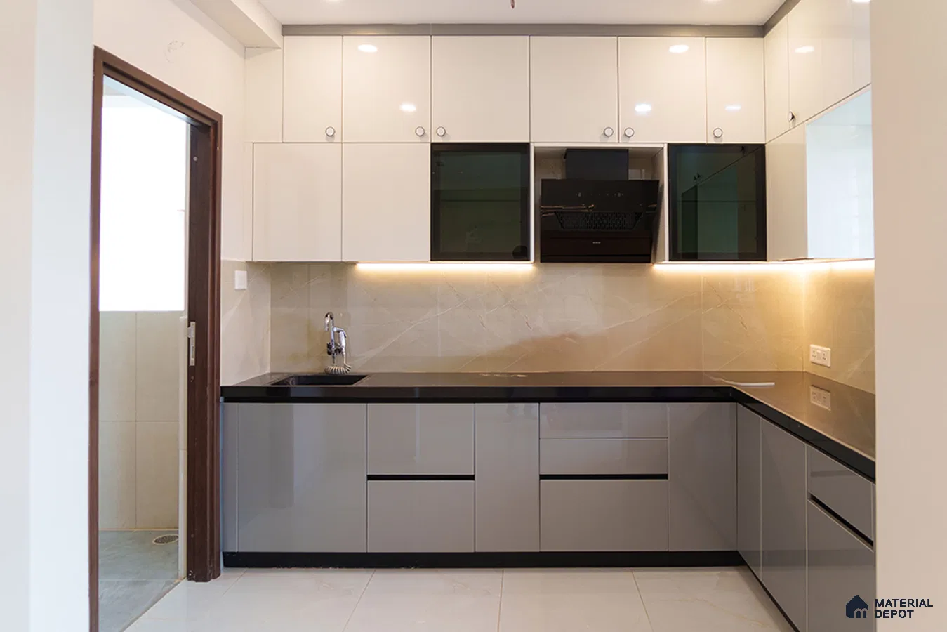 Modern dual tone kitchen with glossy white and grey laminate, black quartz countertop, and beige marble backsplash in Bengaluru | Material Depot