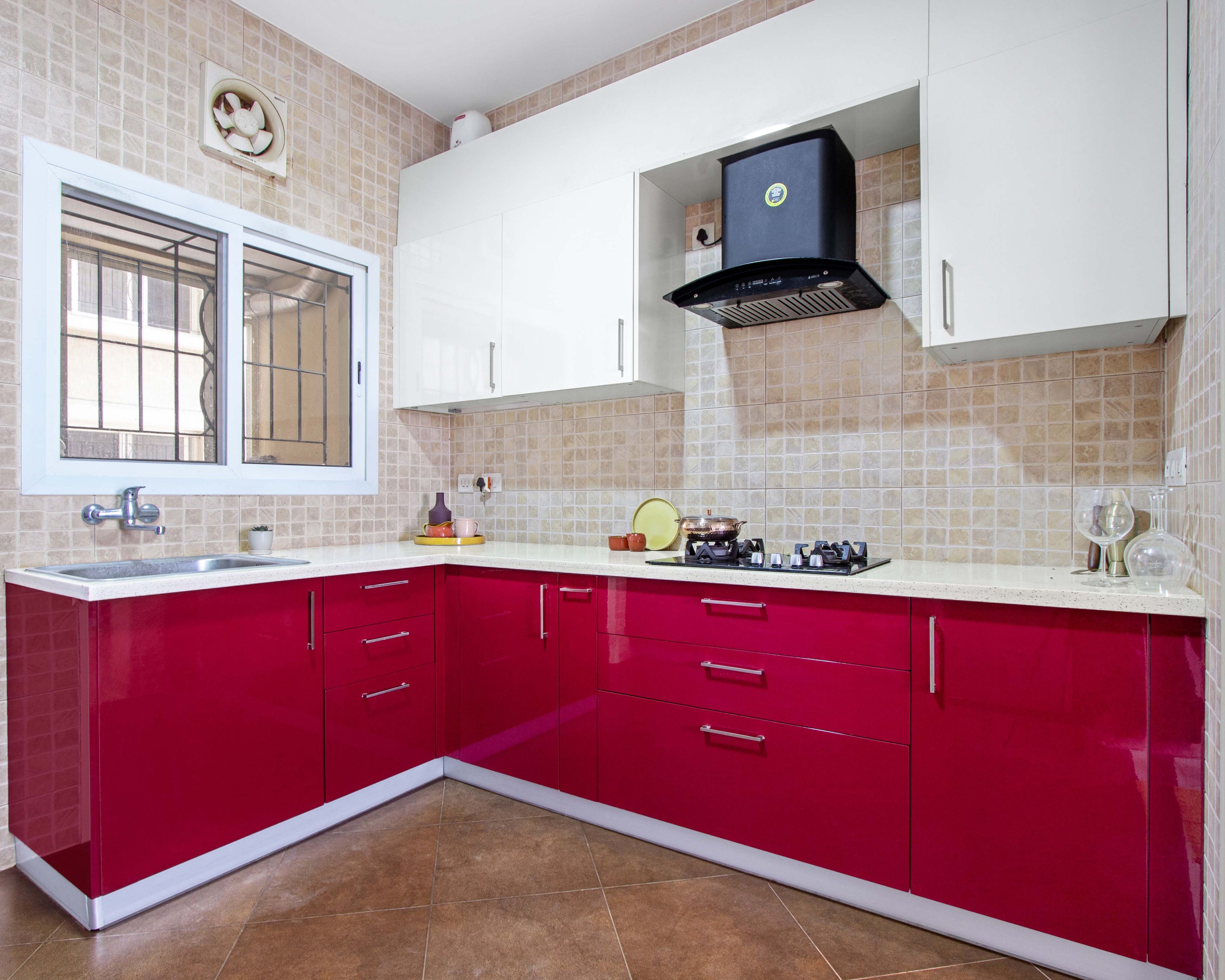 Modern dual tone kitchen with high gloss magenta laminate, frosty white laminate, and beige mosaic wall tiles in Bengaluru | Material Depot